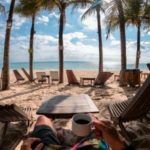 retirement sitting on beach with coffee